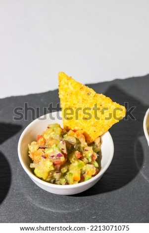 Mexican guacamole sauce with nachos chips