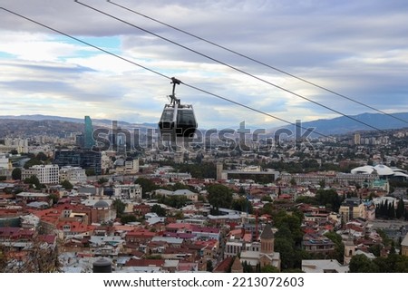 Aerial tramway car of Tbilisi Georgia with cityscape in background Royalty-Free Stock Photo #2213072603