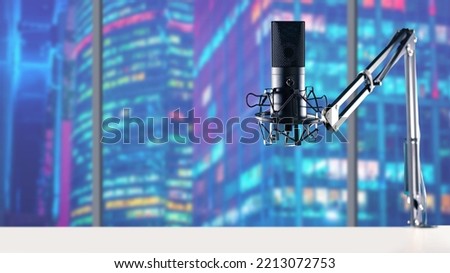 City radio station. Studio microphone on tripod. Microphone on background of city skyscrapers. Microphone for recording audio podcast. Voice equipment. Banner for radio station. Selective focus