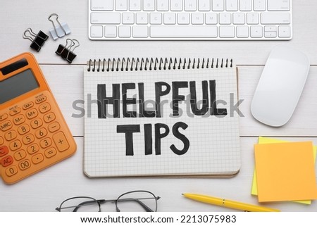 Helpful Tips. Flat lay composition with notebook, calculator and computer keyboard on white wooden table