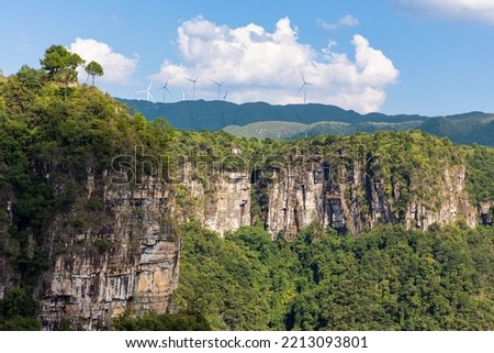 A typical example showing how diverse the Guangdong Canyon is: we can see the valley and alphine meadows co-exist in the same ecosystem. On the top of the hills, pinwheels can also be found. Royalty-Free Stock Photo #2213093801