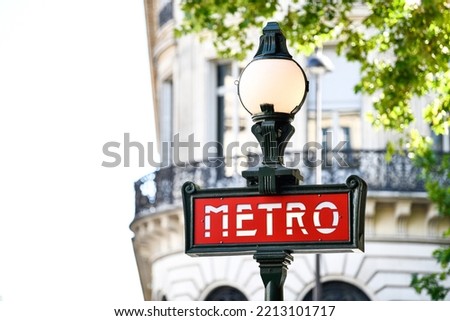 Illustration picture shows a sign with the subway logo (red symbol) in front of a parisian metro (metropolitain) station during a summer day in Paris, France.