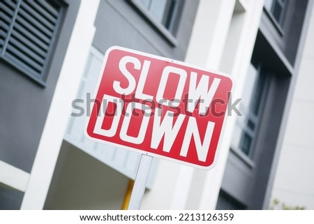 slow down sign against a building 