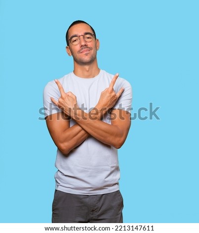 Naughty young man making a rock gesture