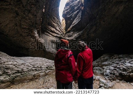 Couple man and woman travel together. Hiking in the gorge. Rocky mountains canyon. Republic of Dagestan tourism Russia. Adventure mood. New adventure experience. Lifestyle travelphoto jorney Royalty-Free Stock Photo #2213147723