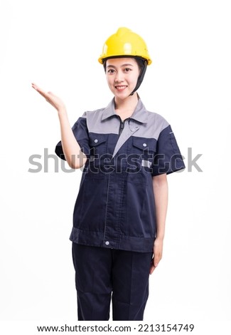A female worker in uniform and hard hat