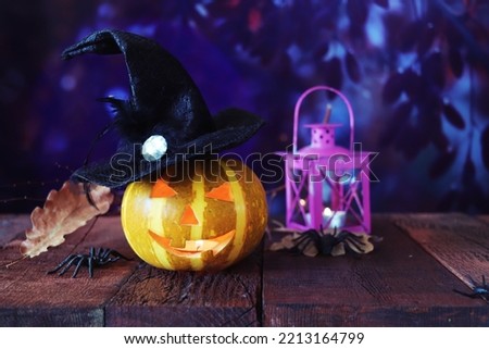 Halloween decorations, pumpkins and a lamp with a burning candle, Halloween celebration, autumn leaves, nature background, evening, festive atmosphere