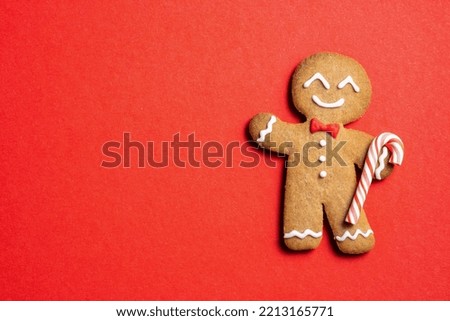 Cute Gingerbread man for Christmas card. Cozy concept of Christmas and winter holidays. Top view. Royalty-Free Stock Photo #2213165771
