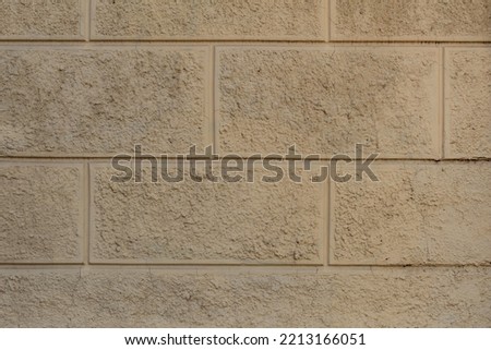 Wall made of concrete blocks with embossed surface fixed by a close-up photo shooting