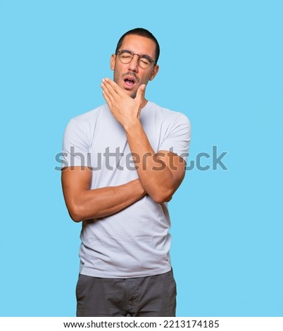 Bored young man yawning gesture