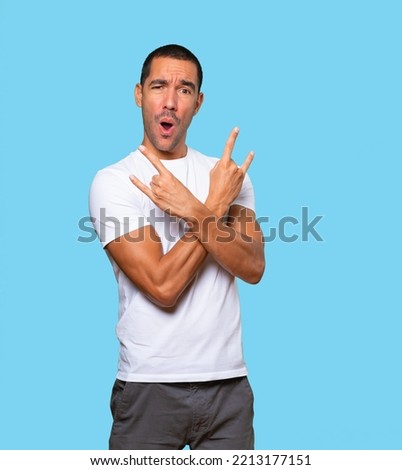 Naughty young man making a rock gesture