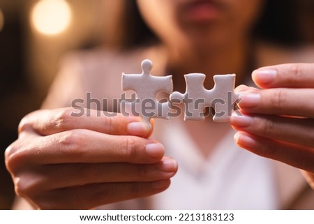 Business person team work holding jigsaw to connecting successful puzzle piece for matching to goals target, success and start up new project in business marketing plan concept