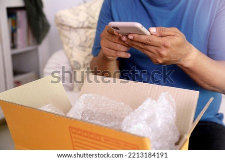 The 40s adult Asian man taking the photos of the product in the mailbox. Royalty-Free Stock Photo #2213184191