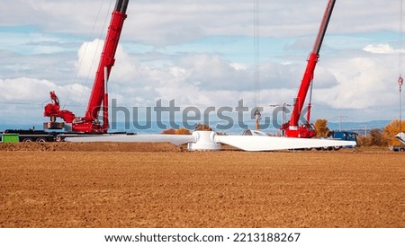 Construction site. dismantling of an old windturbine by crane. Farmland with construction work at the windfarm in Wörrstadt, Germany. Energy saving concept from wind turbine construction. Royalty-Free Stock Photo #2213188267