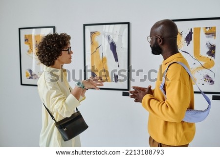 Young people discussing pictures together