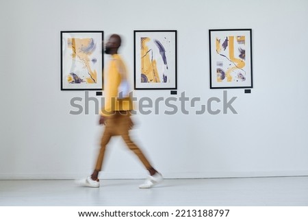 Man walking along art gallery