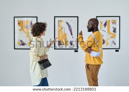People discussing art at gallery