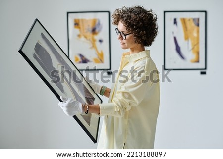 Woman working with art at gallery
