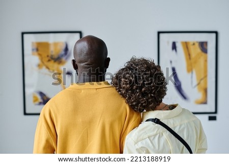 Multiethnic couple enjoying art at gallery