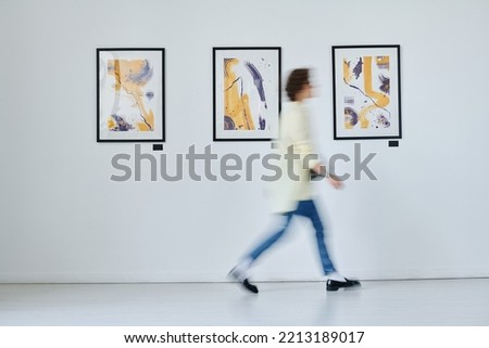 Young woman walking at art gallery