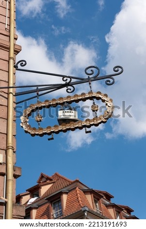  Guild sign of a tailor in the form of an iron in the old town of Colmar in France                               