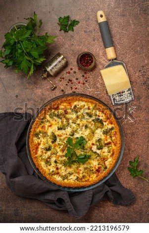 Quiche Lorraine with chicken and broccoli. Pie with vegetables, poultry, cheese, parsley and spices.  Rustic style. Traditional French food. Selective focus, top view and copy space. square picture
