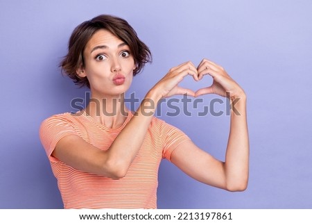 Photo of adorable nice lady dressed striped stylish outfit arm make heart figure symbol empty space isolated on purple color background