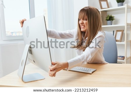 Angry evil blonde businesswoman screaming to desktop Raging after computer software crash error at workplace in modern office. Irritated director work online in financial corporation. Copy space