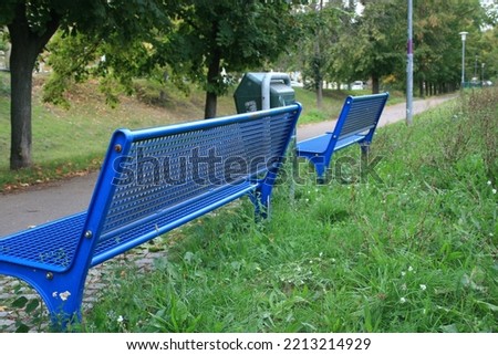 Blue metal bench in the public park
