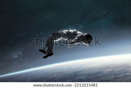 3D illustration of astronaut falling to earth planet. 5K realistic science fiction art. Elements of image provided by Nasa