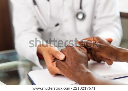 Friendly doctor hands holding patient hand support and hope concept
