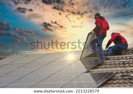 Installing solar photovoltaic panel system. Solar panel technician installing solar panels on roof. Alternative energy ecological concept.
 Royalty-Free Stock Photo #2213228579