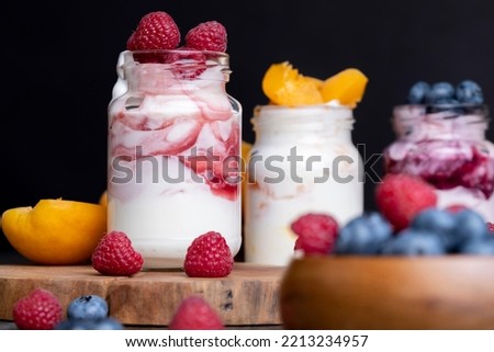 Fresh delicious milk yogurt with raspberry flavor, yogurt with fresh berries and raspberry jam