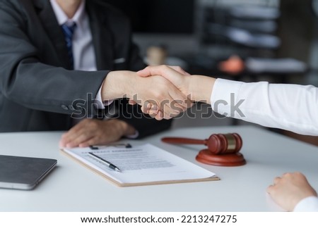 Shaking hands, Business people negotiating a contract. discussing at desk of lawyer, legislation concept.