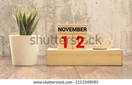 November 12th. Image of november 12 wooden color calendar on blue background. Autumn day. Empty space for text