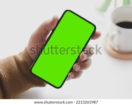 Man Holding Green Screen  Smartphone in Hand Royalty-Free Stock Photo #2213261987