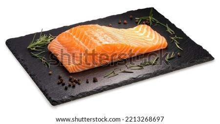 Fresh Salmon fish fillet isolated on white background, Salmon fish fillet with rosemary on black plate over white With clipping path. Royalty-Free Stock Photo #2213268697