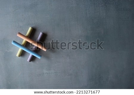 Top view image of colorful chalk and hashtag icon with copy space. Social media, viral, trending concept