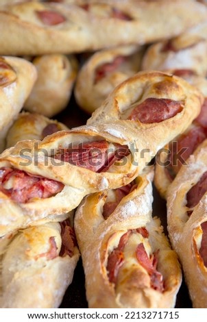 Closeup of stack of stuffed baguettes with sausage on the bakery shelf. Sao Paulo city, Brazil