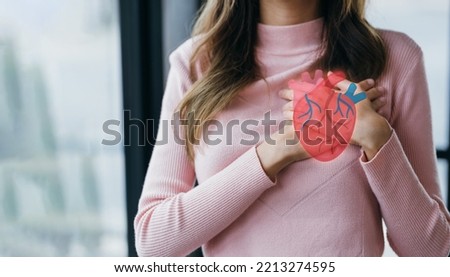 Woman having clutching chest with heart anatomy, heart attack, heart disease, Female with health care and Healthy feminine, World Heart Day concept. Royalty-Free Stock Photo #2213274595