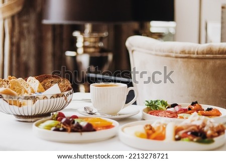 Luxury hotel and five star room service, various food platters, bread and coffee as in-room breakfast for travel and hospitality brand Royalty-Free Stock Photo #2213278721