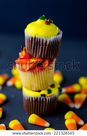 Miniature cupcakes with yellow and orange icing.
