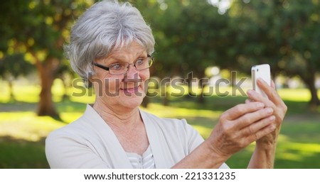 Hip grandma taking selfies at the park