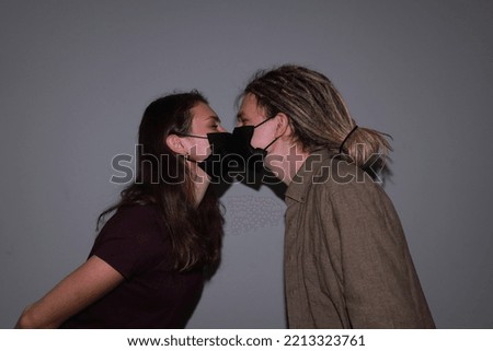 photo of two people kissing in medical masks