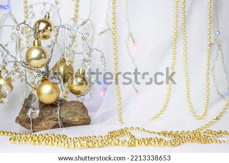 Christmas background with a Christmas tree on which small golden balls hang. Selective focus, a picture for the background. the concept of Christmas and New Year.