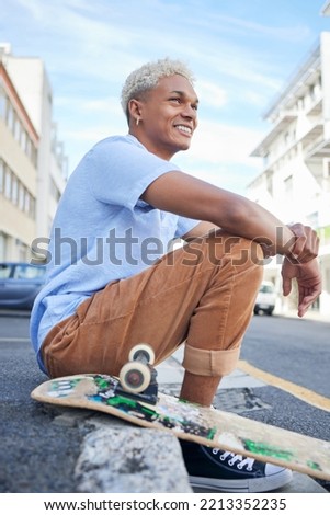 Relax, skateboard and city black man in street of California in summer with Gen Z fashion. Edgy, young and trendy African American skater male in the USA resting on urban road with smile.