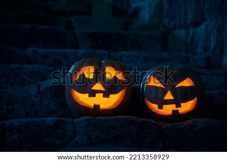 Halloween pumpkins jack p lantern in the yard of an old castle at night in the bright moonlight