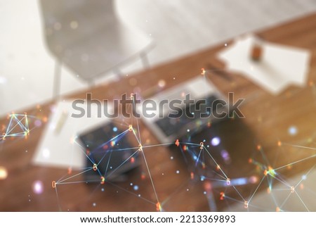 Creative abstract wireless technology hologram and modern desktop with pc on background, artificial intelligence and machine learning concept. Multi exposure