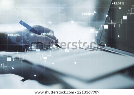 Abstract creative financial graph with world map and with hand writing in notebook on background with laptop, forex and investment concept. Multiexposure