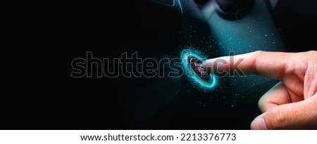 The driver palm as it presses the electric car engine start stop button with a blue light illuminated , panoramic banner with copy space on black background Royalty-Free Stock Photo #2213376773